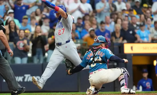 Chicago Cubs' Seiya Suzuki (27) is tagged out at home by Milwaukee Brewers' William Contreras, right, during the seventh inning of a baseball game Saturday, June 27, 2026, in Milwaukee. (AP Photo/Aaron Gash)
