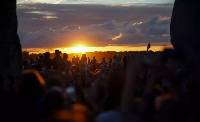 Revelers gather at the ancient stone circle Stonehenge to celebrate the summer solstice, the longest day of the year, near Salisbury, England, Saturday, June 20, 2026. (AP Photo/Alberto Pezzali)