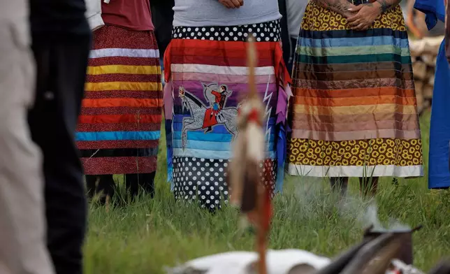 Ladies line up in ribbon skirts during festivities to commemorate the 150th anniversary of the Battle of the Little Bighorn, Wednesday, June 24, 2026, in Crow Agency, Mont. (AP Photo/Tailyr Irvine)