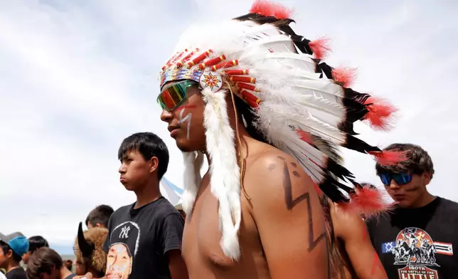The crowd celebrates after the horse charging event during festivities to commemorate the 150th anniversary of the Battle of the Little Bighorn in Crow Agency, Mont., on Thursday, June 25, 2026. (AP Photo/Tailyr Irvine)