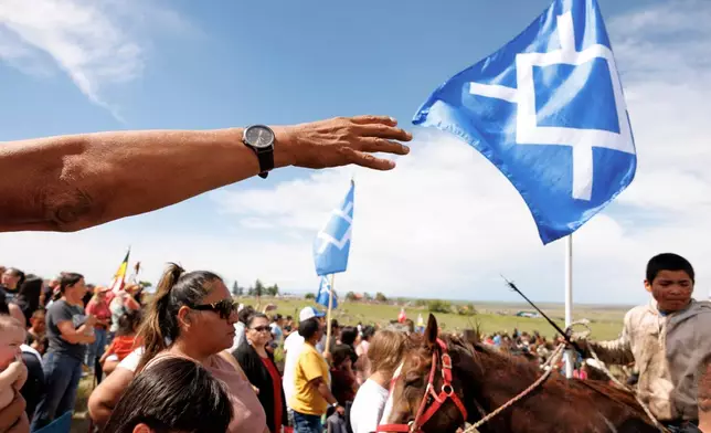 Riders and others gather after the horse charging event during festivities to commemorate the 150th anniversary of the Battle of the Little Bighorn in Crow Agency, Mont., on Thursday, June 25, 2026. (AP Photo/Tailyr Irvine)
