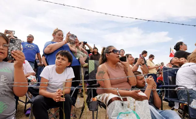 Spectators watch the charging event during festivities to commemorate the 150th anniversary of the Battle of the Little Bighorn in Crow Agency, Mont., on Thursday, June 25, 2026. (AP Photo/Tailyr Irvine)