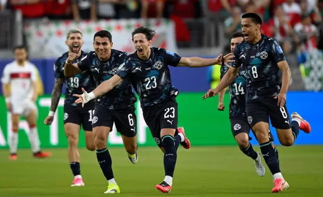 Paraguay's Matias Galarza (23) celebrates with Junior Alonso (6) and Diego Gomez (8) after scoring their opening goal during the World Cup Group D soccer match between Turkey and Paraguay in Santa Clara, Calif., near San Francisco, Friday, June 19, 2026. (AP Photo/Eakin Howard)