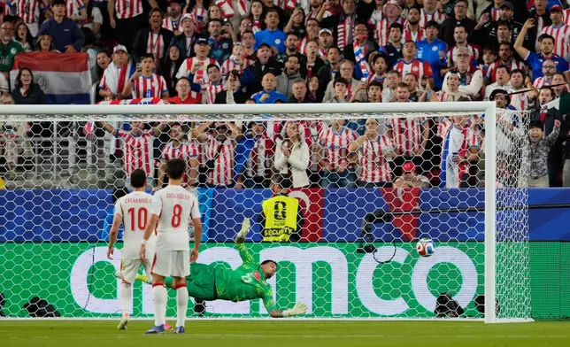 Turkey goalkeeper Ugurcan Cakir (23) makes a save during the World Cup Group D soccer match between Turkey and Paraguay in Santa Clara, Calif., near San Francisco, Friday, June 19, 2026. (AP Photo/Eugene Hoshiko)