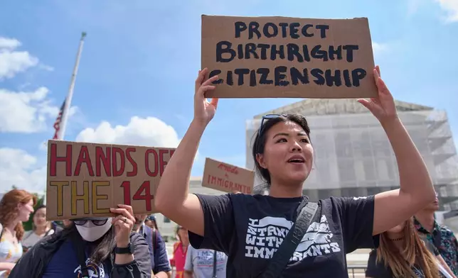 FILE - Hannah Liu, 26, of Washington, holds up a sign in support of birthright citizenship, May 15, 2025, outside of the Supreme Court in Washington. (AP Photo/Jacquelyn Martin, File)
