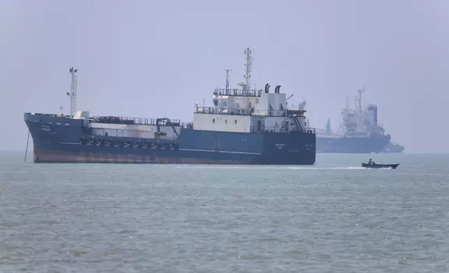 A small motorboat passes anchored vessels in the Strait of Hormuz off Bandar Abbas, Iran, Wednesday, June 17, 2026.(Amirhosein Khorgooi/ISNA via AP)