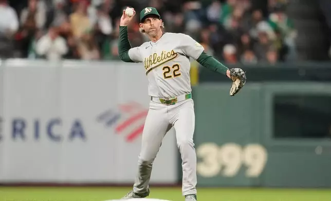 Athletics second baseman Jeff McNeil (22) throws out San Francisco Giants' Casey Schmitt at first base during the sixth inning of a baseball game Wednesday, June 24, 2026, in San Francisco. (AP Photo/Jeff Chiu)