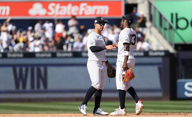 New York Yankees' Anthony Volpe, left, and Jazz Chisholm Jr. celebrate after defeating the Boston Red Sox during a baseball game, Sunday, June 7, 2026, in New York. (AP Photo/Pamela Smith)