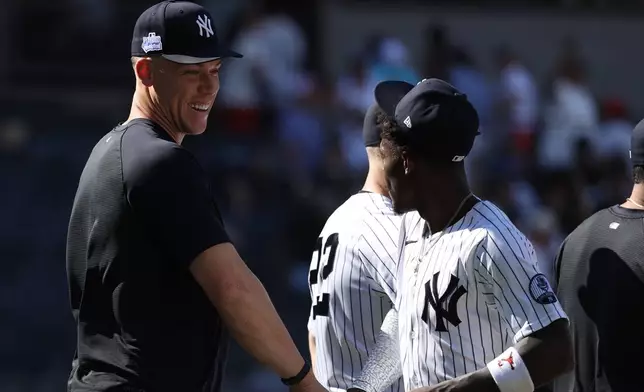 New York Yankees' Aaron Judge, left, celebrates with Jazz Chisholm Jr. after defeating the Boston Red Sox at a baseball game, Sunday, June 7, 2026, in New York. (AP Photo/Pamela Smith)