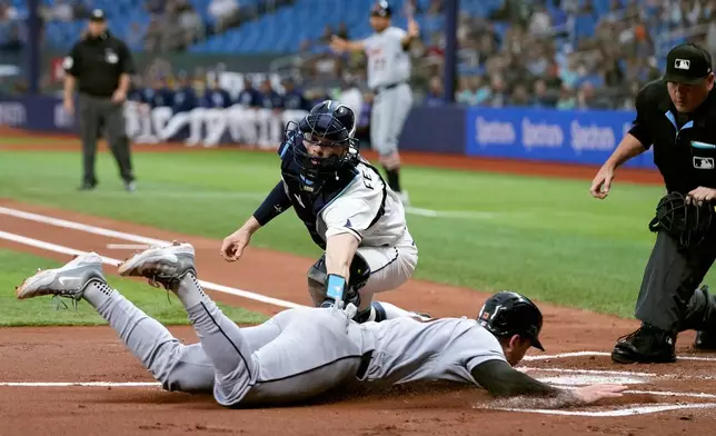 Detroit Tigers' Dillon Dingler (13) slides home safely ahead of the tag by Tampa Bay Rays catcher Hunter Feduccia on a two-run double by Riley Greene during the first inning of a baseball game Monday, June 1, 2026, in St. Petersburg, Fla. (AP Photo/Chris O'Meara)