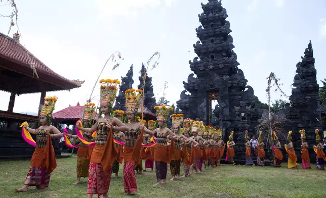 Dancers perform the sacred Rejang dance during Kuningan holiday, which marks the end of the 10-day Galungan festival celebrating the victory of good over evil, in Karangasem, Bali, Indonesia, Saturday, June 27, 2026. (AP Photo/Firdia Lisnawati)