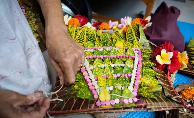 A headwear is prepared for a dancer to perform the sacred Rejang dance during Kuningan holiday, which marks the end of the 10-day Galungan festival celebrating the victory of good over evil, in Karangasem, Bali, Indonesia, Saturday, June 27, 2026. (AP Photo/Firdia Lisnawati)