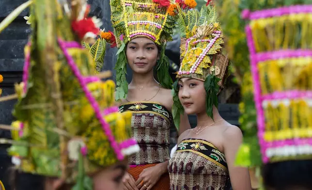 Dancers wait to perform the sacred Rejang dance during Kuningan holiday, which marks the end of the 10-day Galungan festival celebrating the victory of good over evil, in Karangasem, Bali, Indonesia, Saturday, June 27, 2026. (AP Photo/Firdia Lisnawati)
