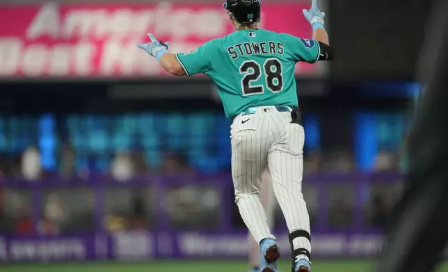 Miami Marlins' Kyle Stowers runs the bases and celebrates after hitting a home run during the second inning of a baseball game against the San Francisco Giants, Sunday, June 21, 2026, in Miami. (AP Photo/Jim Rassol)