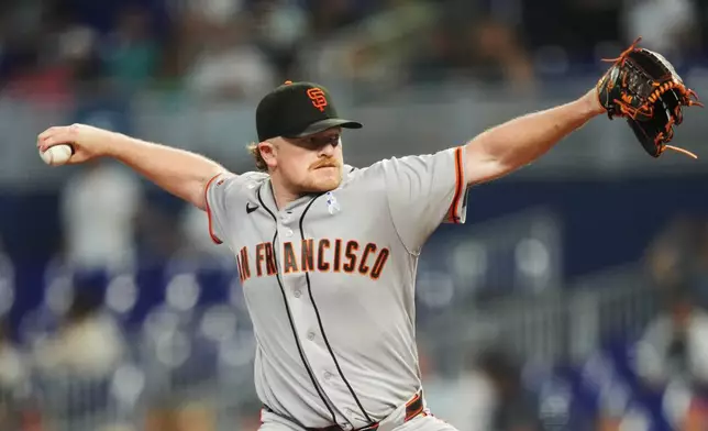 San Francisco Giants pitcher Logan Webb throws against the Miami Marlins during the first inning of a baseball game, Sunday, June 21, 2026, in Miami. (AP Photo/Jim Rassol)