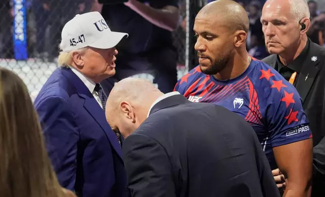 President Donald Trump, left, congratulates Ciryl Gane following his win in a heavyweight interim title bout against Alex Pereira at UFC Freedom 250 on the South Lawn of the White House, Monday, June 15, 2026, in Washington. (AP Photo/Mark Schiefelbein)