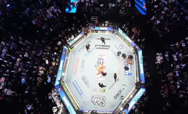 Alex Pereira, far right, is attended to, as Ciryl Gane lays in the center of the ring during UFC Freedom 250 on the South Lawn of the White House, Monday, June 15, 2026, in Washington. (AP Photo/Alex Brandon, Pool)