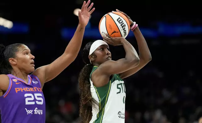 Seattle Storm guard Flau'jae Johnson, right, tries to get off a shot as Phoenix Mercury forward Alyssa Thomas (25) comes in for the block during the first half of a WNBA basketball game, Saturday, June 20, 2026, in Phoenix. (AP Photo/Ross D. Franklin)
