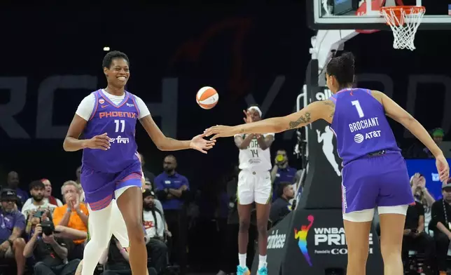 Phoenix Mercury forward Valeriane Ayayi (11) smiles while celebrating a 3-pointer against the Seattle Storm with Mercury forward Noemie Brochant (1) during the first half of a WNBA basketball game, Saturday, June 20, 2026, in Phoenix. (AP Photo/Ross D. Franklin)
