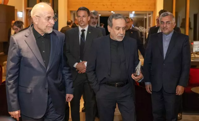 Iranian Foreign Minister Seyyed Abbas Araghchi, center, and Speaker of the Islamic Parliament of Iran Mohammed Bagher Ghalibaf, left, arrive at the Buergenstock resort in Obbuergen, near Lucerne, Switzerland, early Sunday, June 21, 2026. (Urs Flueeler/Keystone, Pool via AP)