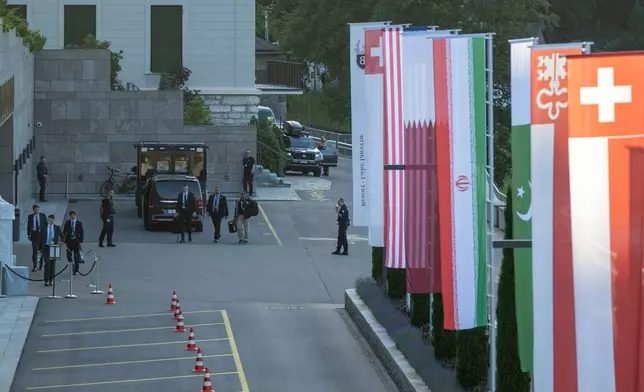 Flags of the U.S., Qatar, Iran, Pakistan, Nidwalden and Switzerland, from left, are seen at the Buergenstock resort in Obbuergen, near Lucerne, Switzerland, Sunday, June 21, 2026. (Urs Flueeler/Keystone Pool via AP)