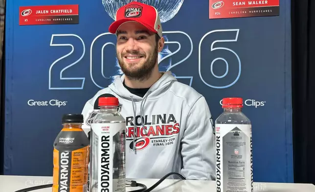 Carolina Hurricanes defenseman Sean Walker speaks during the Stanley Cup Final media day Monday, June 1, 2026 before the start of the series in Raleigh, N.C. (AP Photo/Aaron Beard)
