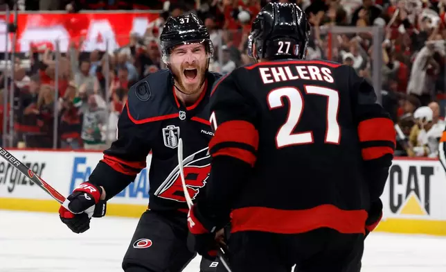Carolina Hurricanes' Andrei Svechnikov (37) celebrates after his goal with Nikolaj Ehlers (27) during the second period in Game 5 of the NHL hockey Stanley Cup Final series against the Vegas Golden Knights in Raleigh, N.C., Thursday, June 11, 2026. (AP Photo/Karl DeBlaker)
