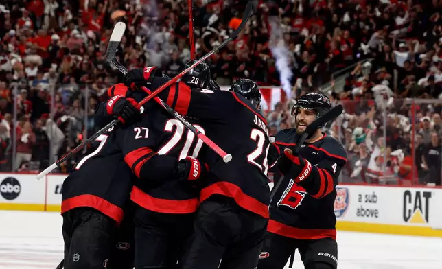 Carolina Hurricanes players celebrate after a goal by Andrei Svechnikov during the second period in Game 5 of the NHL hockey Stanley Cup Final series against the Vegas Golden Knights in Raleigh, N.C., Thursday, June 11, 2026. (AP Photo/Karl DeBlaker)