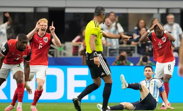 Argentina's Lionel Messi falls during the World Cup Group J soccer match against Austria in Arlington, Texas, near Dallas, Monday, June 22, 2026. (AP Photo/Tony Gutierrez)