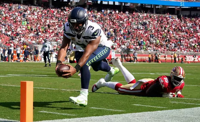 FILE - Seattle Seahawks quarterback Russell Wilson (3) runs for a touchdown past San Francisco 49ers defensive tackle Javon Kinlaw (99) during the second half of an NFL football game in Santa Clara, Calif., Oct. 3, 2021. (AP Photo/Tony Avelar, File)