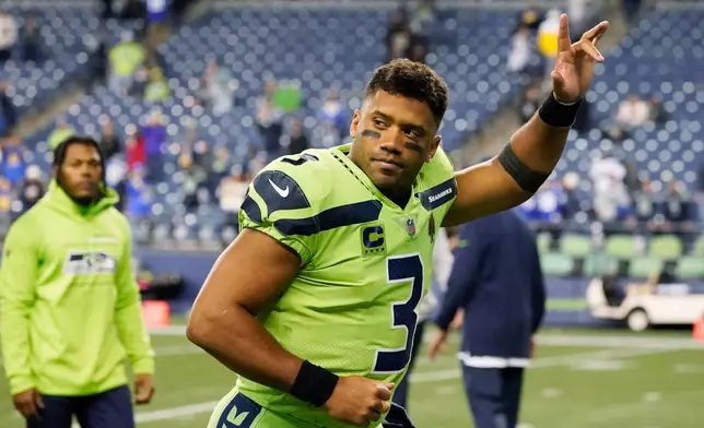 FILE - Seattle Seahawks quarterback Russell Wilson waves to fans as he leaves the field after an NFL football game against the Los Angeles Rams, Oct. 7, 2021, in Seattle. (AP Photo/Elaine Thompson, File)