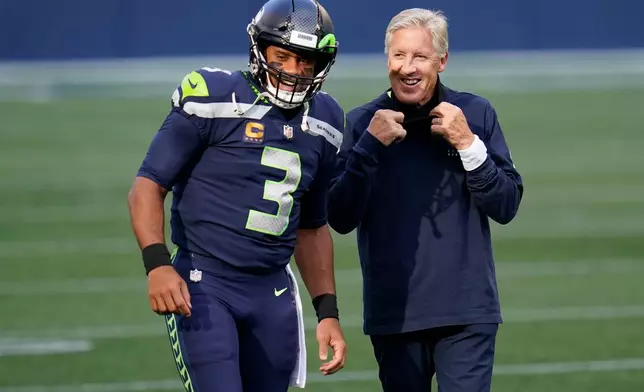 FILE - Seattle Seahawks quarterback Russell Wilson (3) talks with head coach Pete Carroll before an NFL football game against the New England Patriots, Sept. 20, 2020, in Seattle. (AP Photo/Elaine Thompson, File)