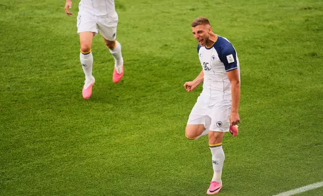 Bosnia's Jovo Lukic (25) celebrates after scoring the opening goal during the World Cup Group B soccer match between Canada and Bosnia in Toronto, Friday, June 12, 2026. (AP Photo/Jared Freed)
