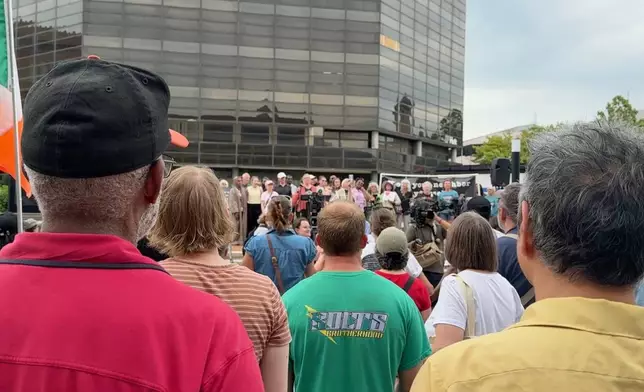 This photo made from video shows residents watching members of a choir sing while attending a rally in support of Haitian people on Thursday, June 25, 2026, in Springfield, Ohio, after the United States Supreme Court ruled that the Trump administration is allowed to end TPS for Haitians and Syrians. (AP Photo/Patrick Aftoora-Orsagos)