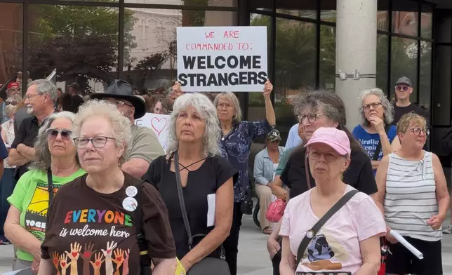 This photo made from video shows people at a rally in support of Haitians on Thursday, June 25, 2026, in Springfield, Ohio, after the United States Supreme Court ruled that the Trump administration can end temporary protected status for Haitians and Syrians. (AP Photo/Patrick Aftoora-Orsagos)