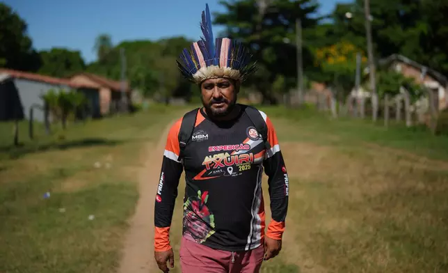 Indigenous chief Cleiton Javae walks in his community at the Txuiri village on Bananal Island in Formoso do Araguaia, Tocantins state, Brazil, Thursday, May 21, 2026. (AP Photo/Andre Penner)