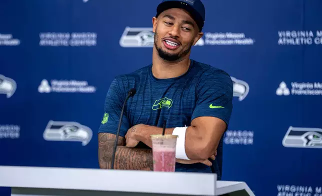 Seattle Seahawks wide receiver Jaxon Smith-Njigba answers a reporter's question after a NFL football practice at the team's training facility, Tuesday, June 9, 2026, in Renton, Wash. (AP Photo/Stephen Brashear)