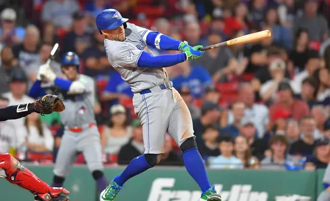 Toronto Blue Jays' George Springer hits a two-run home run in the ninth inning of a baseball game against the Boston Red Sox, Tuesday, June 16, 2026, in Boston. (AP Photo/Steven Senne)