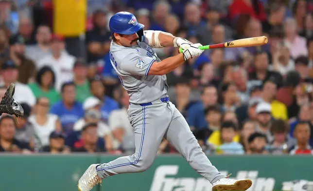 Toronto Blue Jays' Davis Schneider hits a one-run double allowing Kazuma Okamoto to score in the sixth inning of a baseball game against the Boston Red Sox, Tuesday, June 16, 2026, in Boston. (AP Photo/Steven Senne)