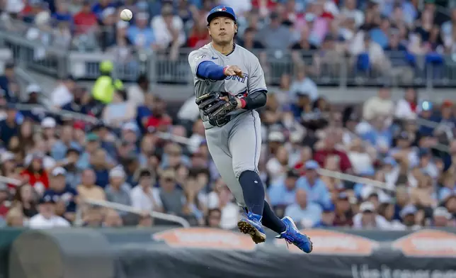 Toronto Blue Jays third baseman Kazuma Okamoto (7) fields a single hit by Atlanta Braves' Ronald Acuna Jr. during the third inning of a baseball game, Thursday, June 4, 2026, in Atlanta. (AP Photo/Erik S. Lesser)