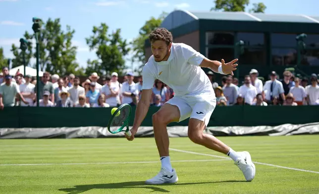 Pablo Carreno Busta of Spain returns the ball to Denis Shapovalov of Canada in their first round men's singles match at the Wimbledon Tennis Championships in London, Monday, June 29, 2026. (AP Photo/Maja Smiejkowska)