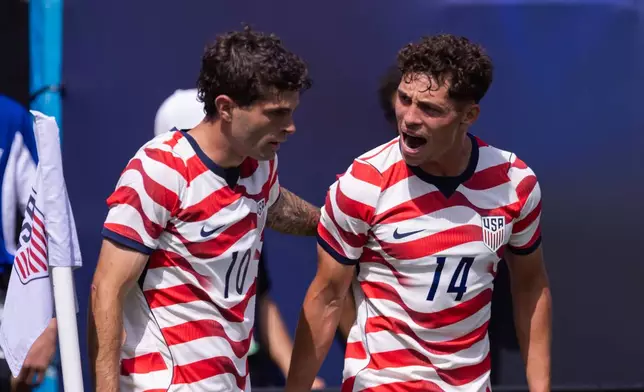 United States forward Christian Pulisic (10) celebrates with midfielder Sebastian Berhalter (14) after scoring in the first half against Senegal in an international friendly soccer match Sunday, May 31, 2026, in Charlotte, N.C. (AP Photo/Scott Kinser)