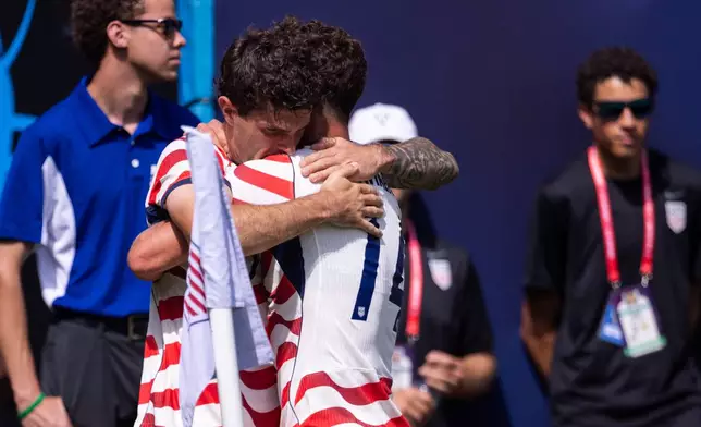 United States forward Christian Pulisic, center left, celebrates with midfielder Sebastian Berhalter (14) after scoring in the first half against Senegal in an international friendly soccer match Sunday, May 31, 2026, in Charlotte, N.C. (AP Photo/Scott Kinser)