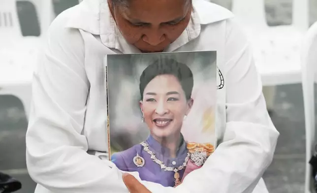 A person holds a picture of the late Thailand Princess Bajrakitiyabha Mahidol in Bangkok, Thailand, Friday, June 12, 2026. (AP Photo/Sakchai Lalit)
