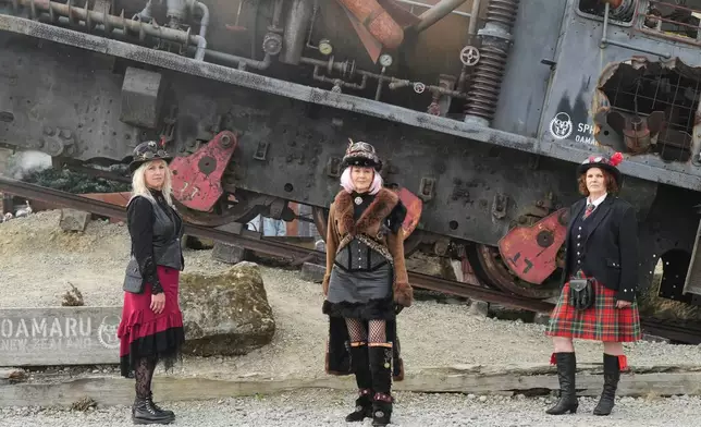 Steampunk NZ Festival attendees Fiona Hilton, left, Sandy Jones and Priscilla Martin, right, pose for a portrait during the annual event in Ōamaru, New Zealand, on May 30, 2026. (AP Photo/Charlotte Graham-McLay)