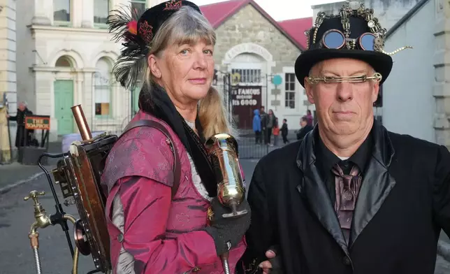 Steampunk NZ Festival attendees Juliet Thorn and Greg Thorn, dressed as their steampunk personas Lady Sarsaparilla Ovabyte and Captain Bob McSpoon, pose for a portrait during the annual event in Ōamaru, New Zealand, on May 29, 2026. (AP Photo/Charlotte Graham-McLay)