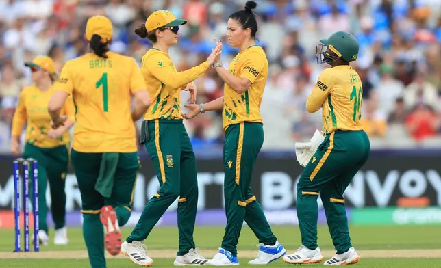 South Africa's Marizanne Kapp (centre right) celebrates taking the wicket of India's Smriti Mandhana during the ICC Women's T20 World Cup match at Emirates Old Trafford, Manchester, England, Sunday June 21, 2026. (Nigel French/PA via AP)