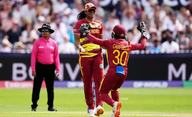 West Indies' Hayley Matthews, left, celebrates taking the wicket of Sri Lanka's Harshitha Samarawickrama during the ICC Women's T20 World Cup match between Sri Lanka and West Indies, in Manchester, England, Sunday, June 21, 2026. ( Jacob King/PA via AP)