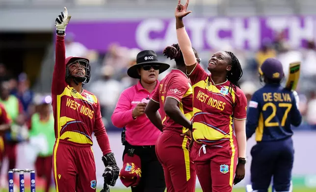 West Indies' Aaliyah Alleyne, right, celebrates taking the wicket of Sri Lanka's Kavisha Dilhari during the ICC Women's T20 World Cup match between Sri Lanka and West Indies, in Manchester, England, Sunday, June 21, 2026. ( Jacob King/PA via AP)