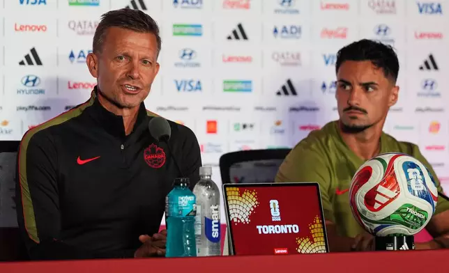 Canada head coach Jesse Marsch, left, with Stephen Eustaquio, speaks during a press conference, Thursday, June 11, 2026, in Toronto, on the eve of the team's World Cup soccer match against Bosnia. (AP Photo/Stephanie Scarbrough)